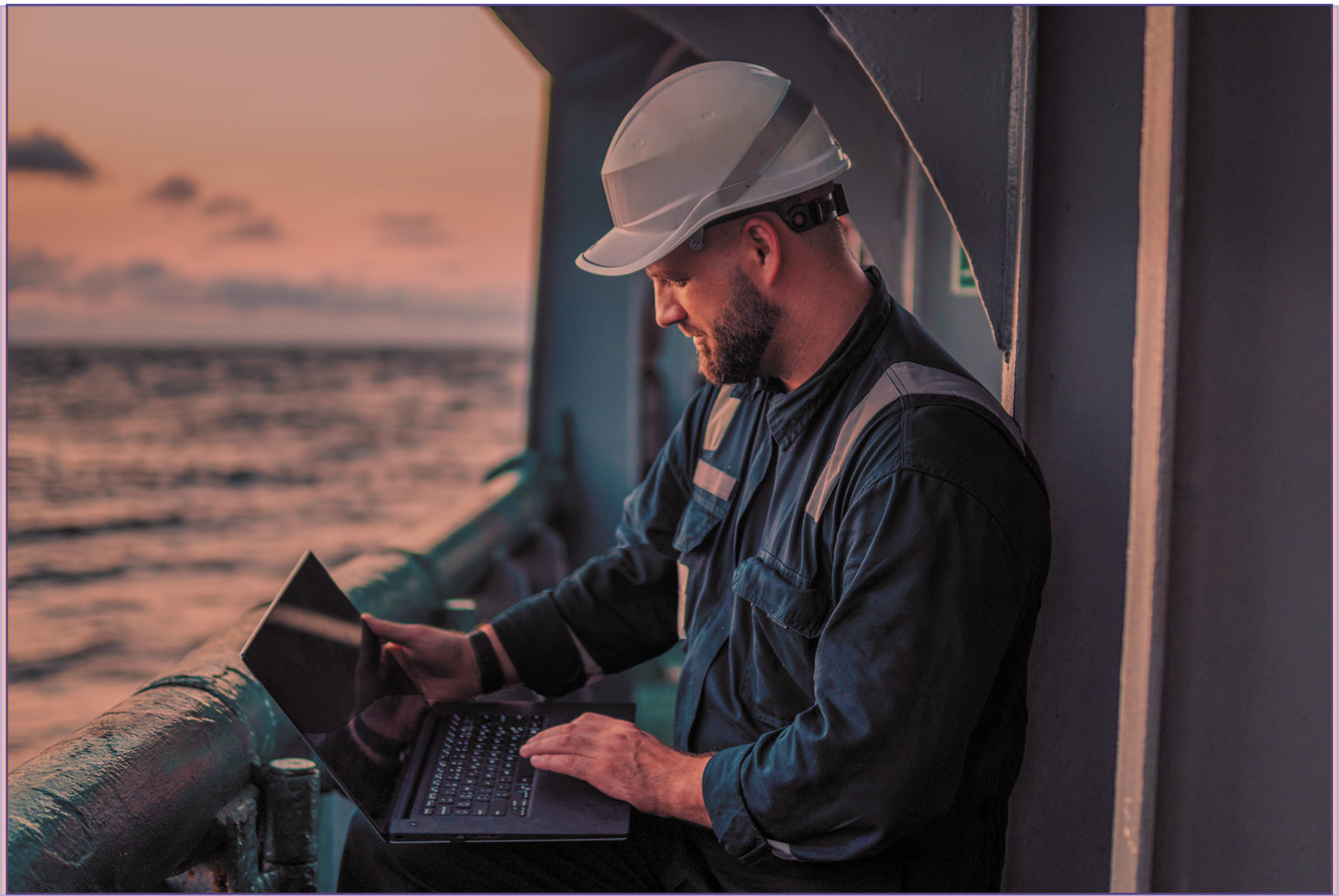 Technician working on computer while on board a ship