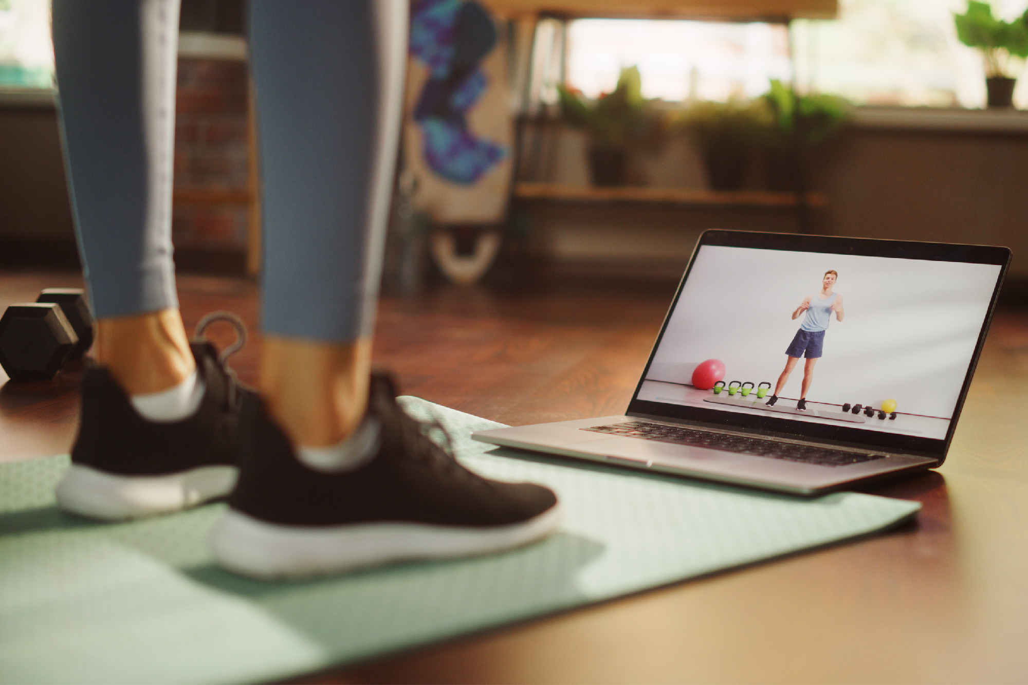 Photo of fitness video playing on laptop at home