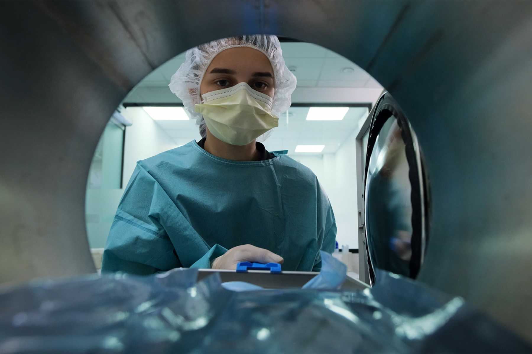 Lab technician wearing hair covering and face mask