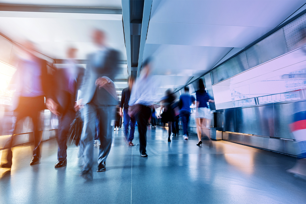 Business people rushing in the lobby.